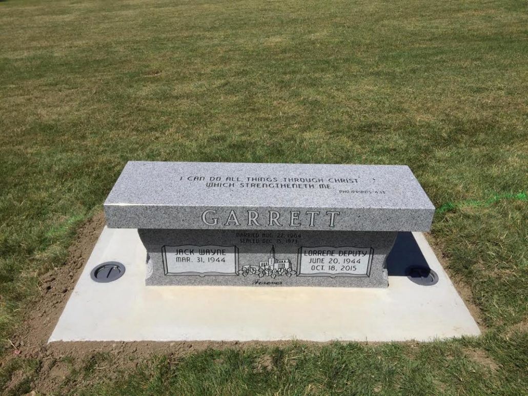 Grave marker with a bench, Garrity etched in stone, set in a cemetery.
