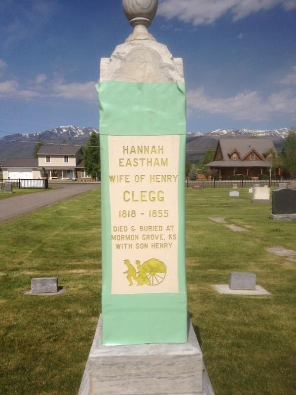 Tombstone for Hannah Eastham Clegg, 1818-1855, in a sunny cemetery with mountains in the background.