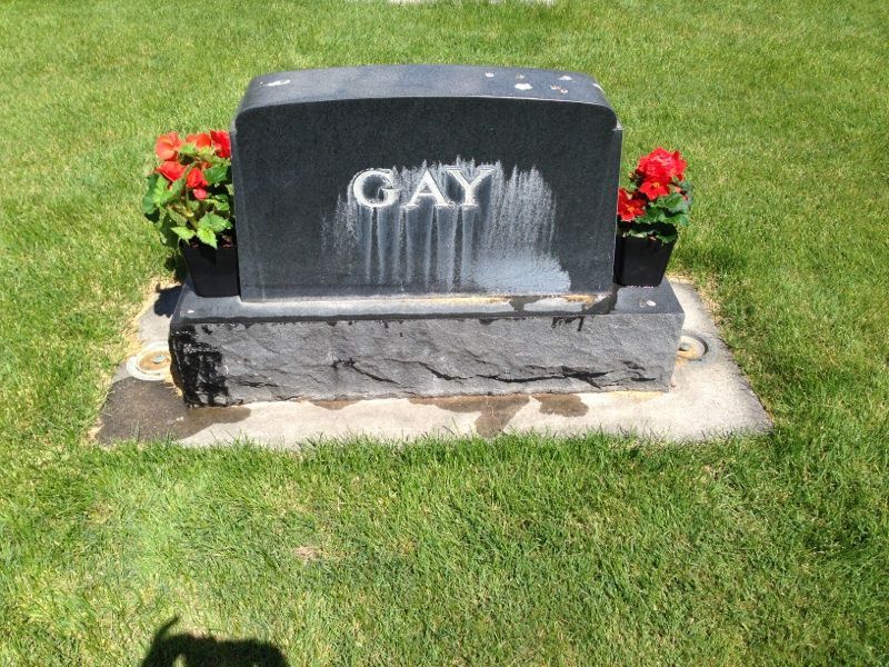 Black headstone with the last name GAY - before