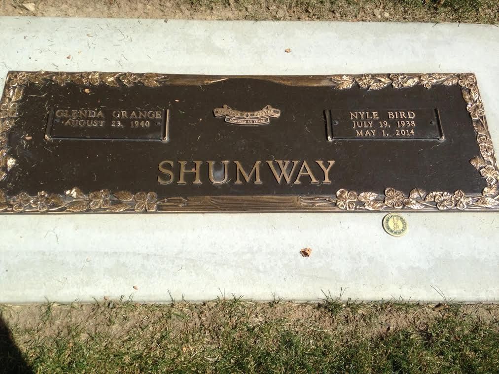 Bronze headstone for Glenda Grange Shumway and Nila Bird Shumway in a cemetery.