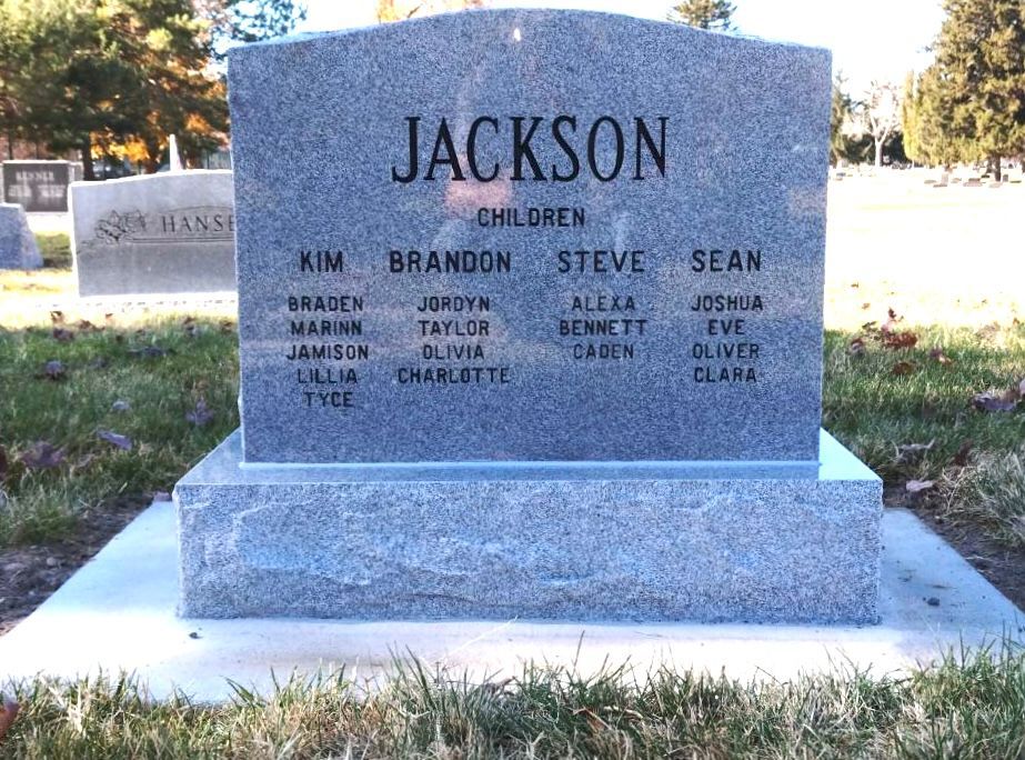 Gray headstone inscribed with the surname JACKSON and the names of the children buried there.