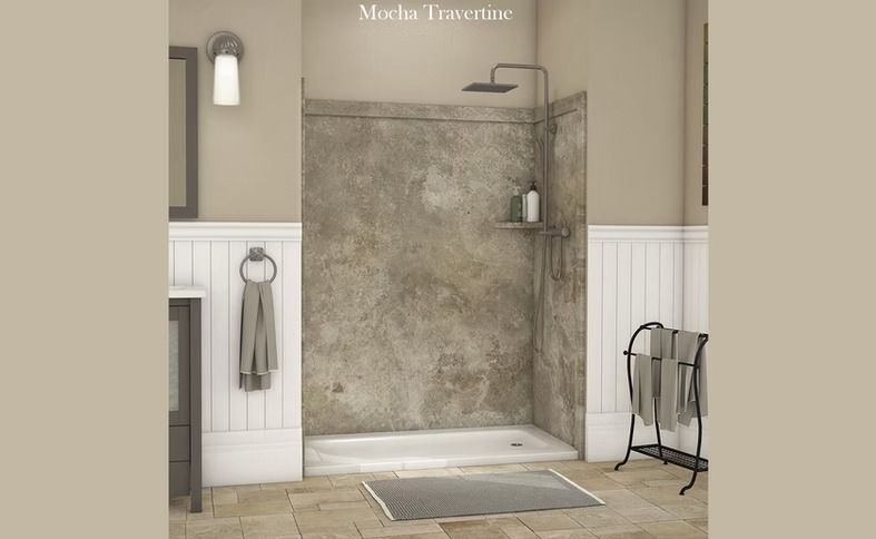 A bathroom with a concrete-look shower stall, gray tile floor, white wainscoting, and tan walls.