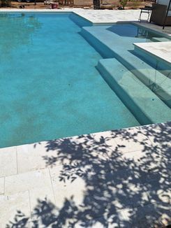 A large swimming pool with stairs leading up to it.