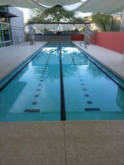 A large swimming pool with a canopy over it