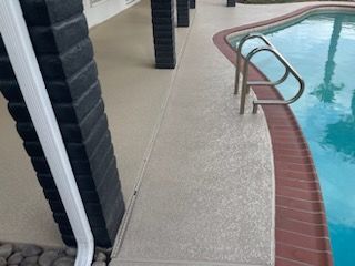 A swimming pool with a walkway leading to it.