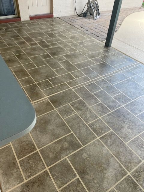 A patio with a tiled floor and a table