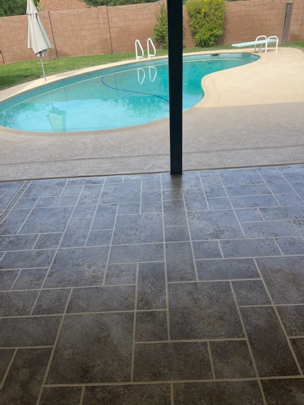 A view of a swimming pool from a tiled floor