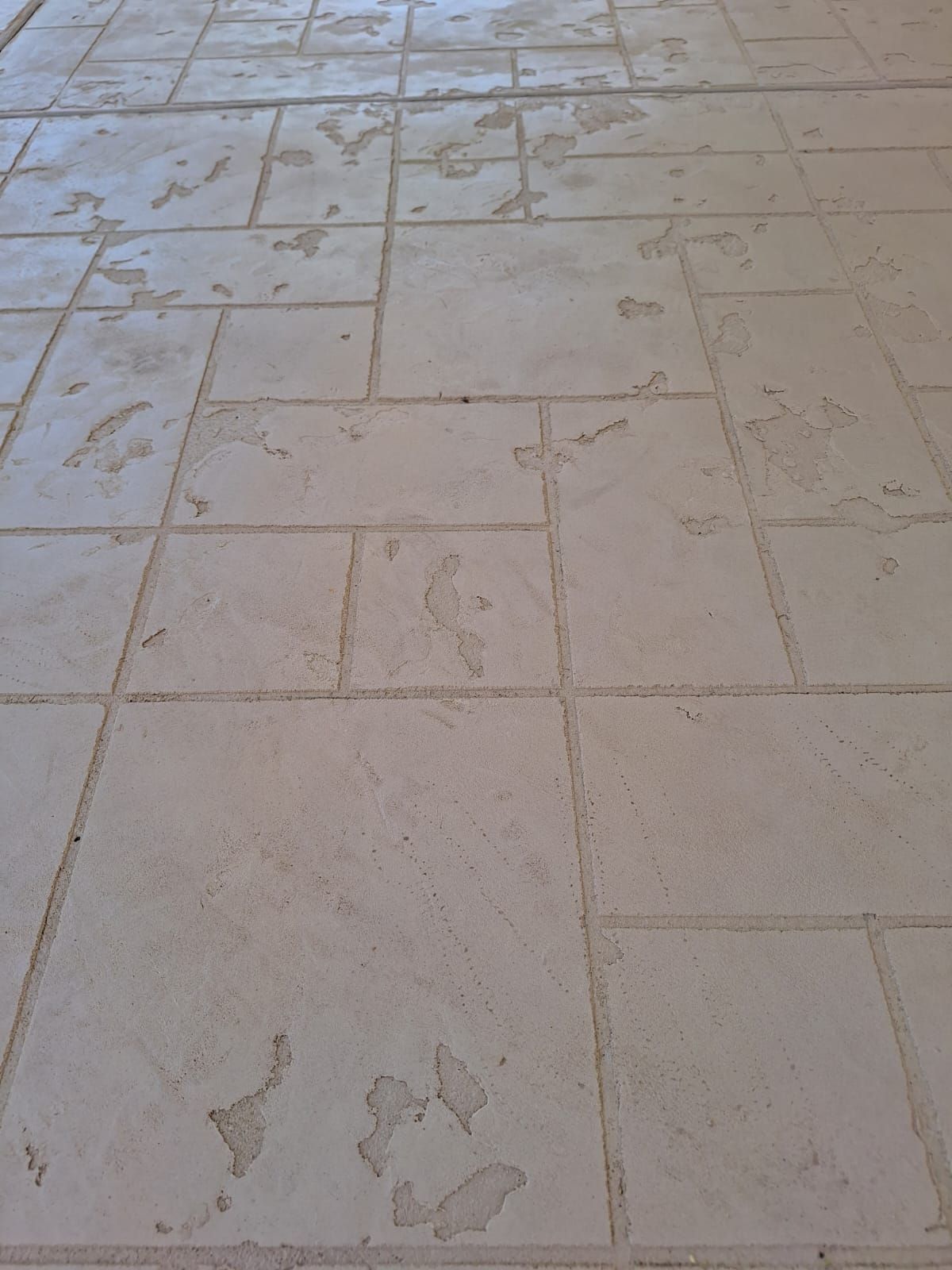 A close up of a tiled floor with a pattern on it.