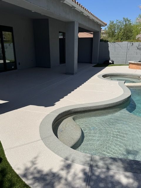 A swimming pool with a curved edge in front of a house