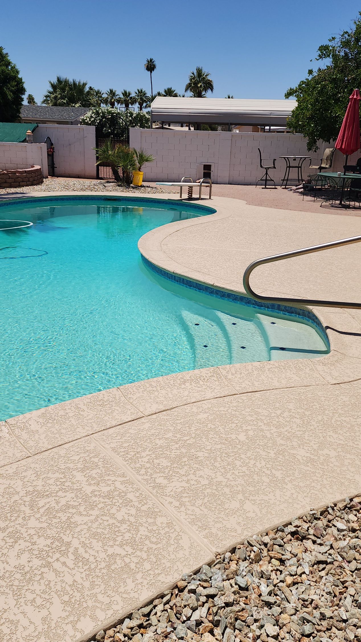 A large swimming pool with stairs leading to it