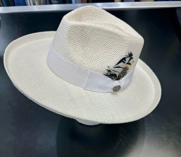 A white fedora hat is on a mannequin head