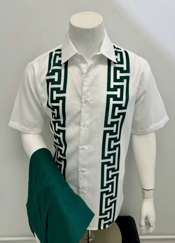 A man is wearing a white shirt with a green greek key design on the sleeves.
