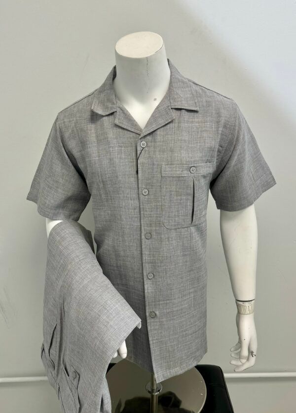 A mannequin is wearing a grey shirt and pants.