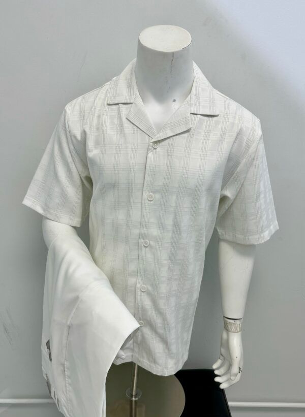 A mannequin is wearing a white shirt and pants.