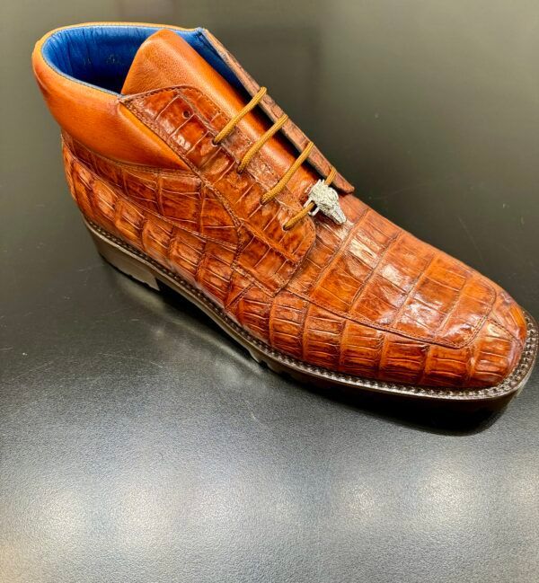 A brown shoe with a blue lining is on a table