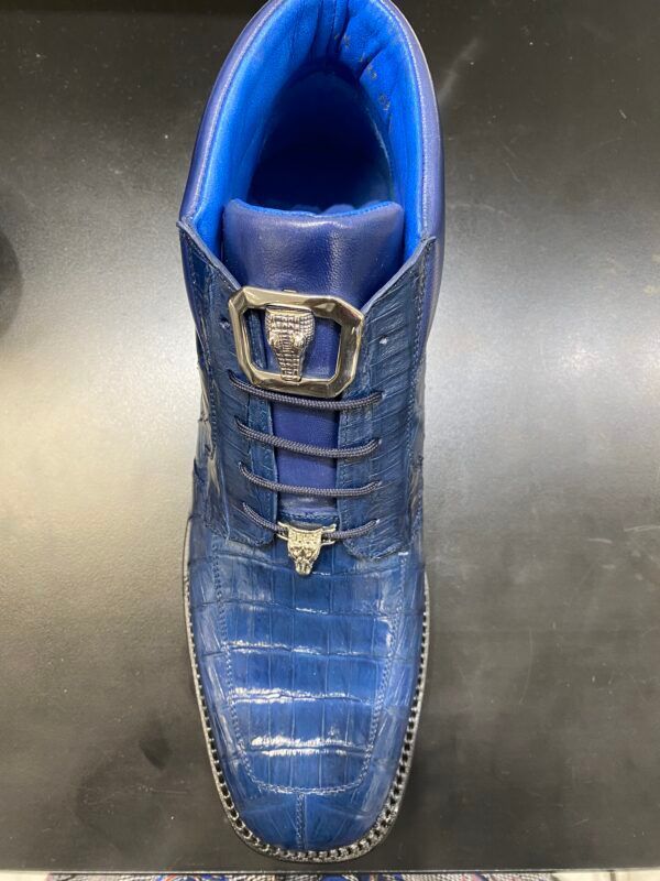 A pair of blue shoes are sitting on a table.