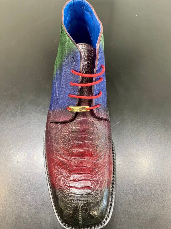 A pair of colorful shoes with red laces on a black surface.