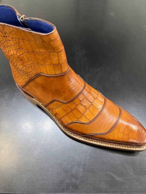 A close up of a brown boot with a blue lining
