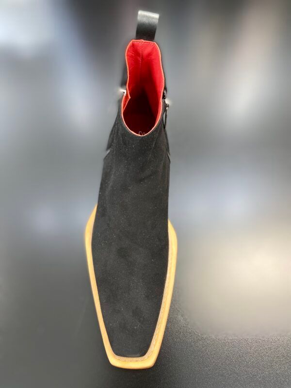 A pair of black boots with a red lining