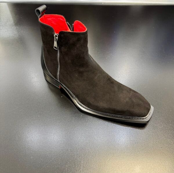A pair of black suede boots with a red lining
