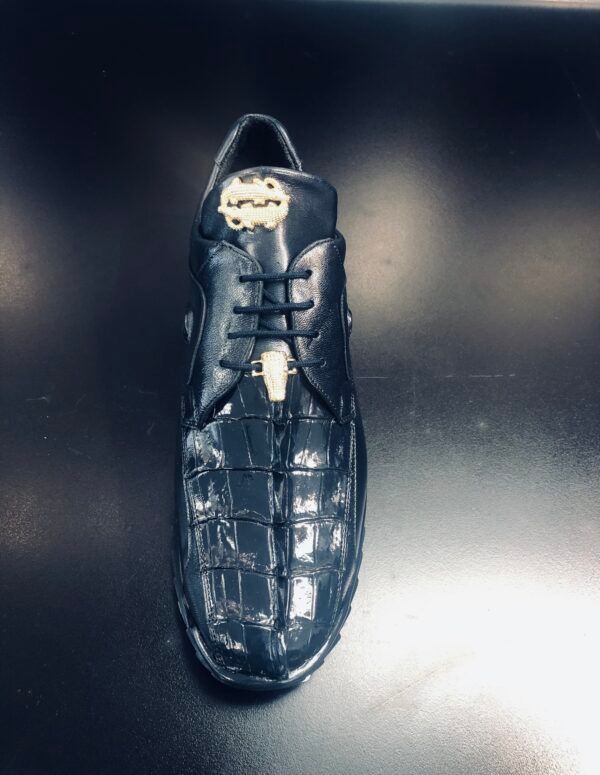 A pair of black shoes is sitting on a black table.