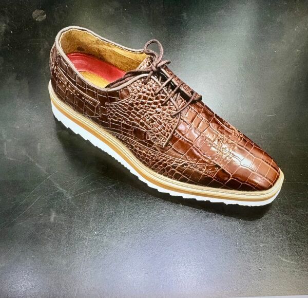 A pair of brown shoes on a black surface