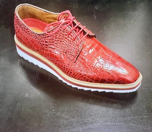 A pair of red shoes on a black surface