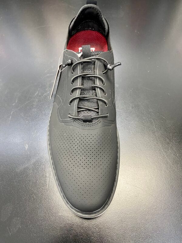 A pair of gray shoes with holes in them are sitting on a table.