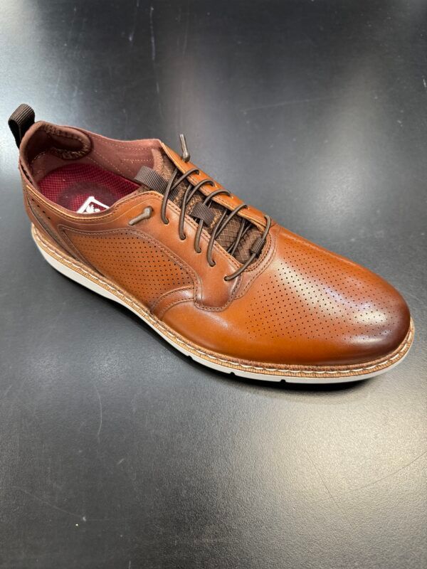 A pair of brown shoes on a black surface