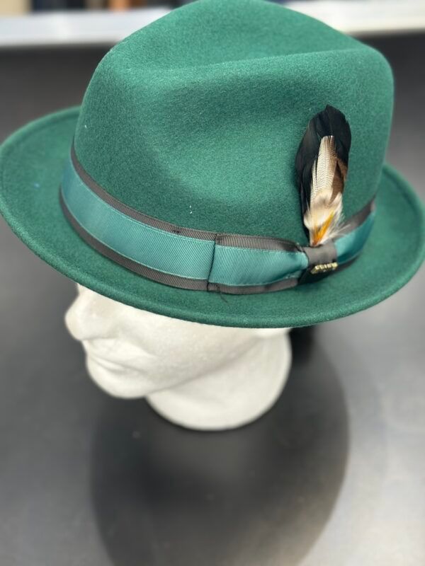 A green fedora hat is on a mannequin head
