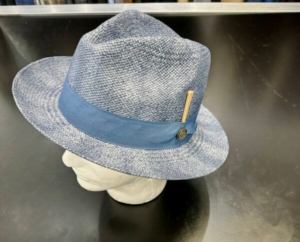 A hat with a blue ribbon is on a mannequin head