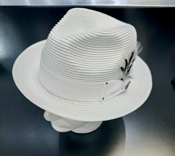 A white fedora hat with feathers sits on a mannequin head