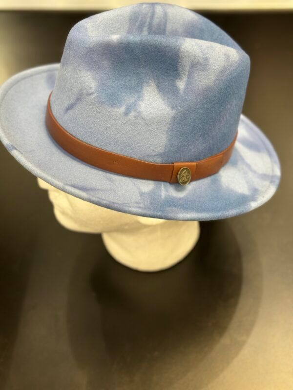 A blue hat with a brown band is on a mannequin head.