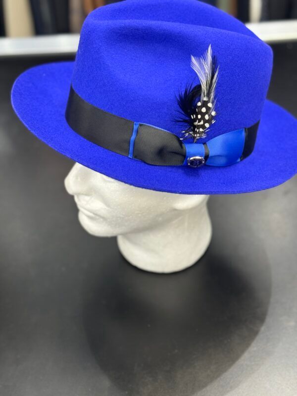 A blue fedora hat with feathers sits on a mannequin head