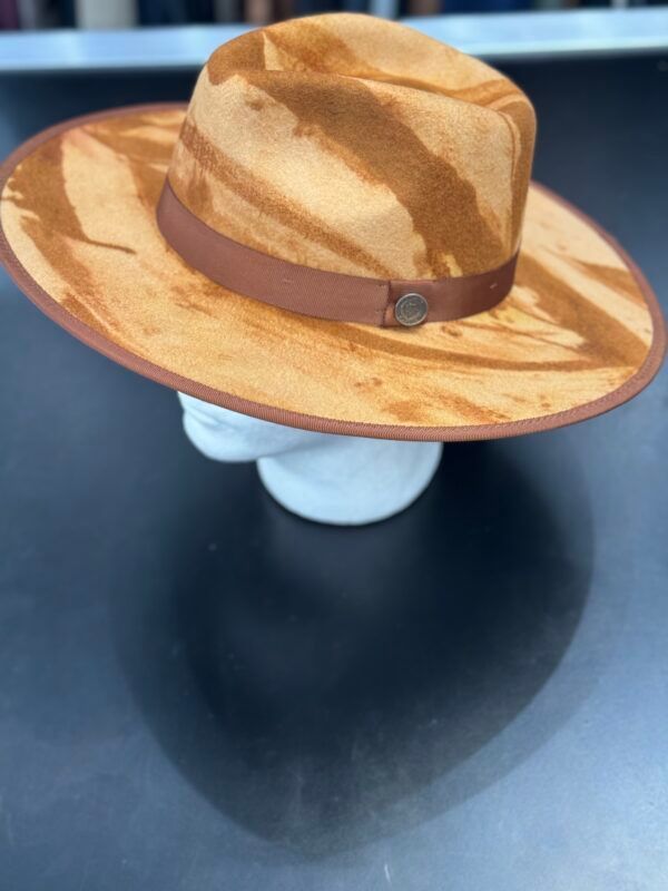 A brown hat with a brown band is on a mannequin head