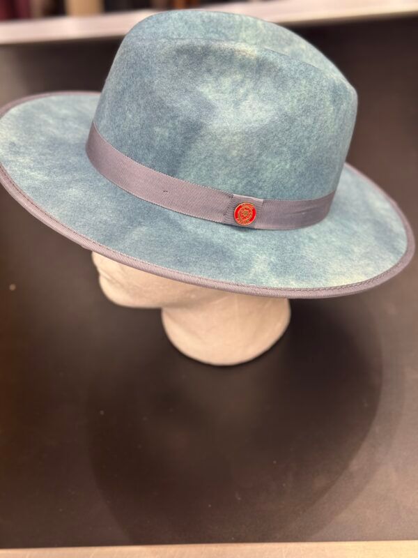 A blue fedora hat is sitting on top of a mannequin head.