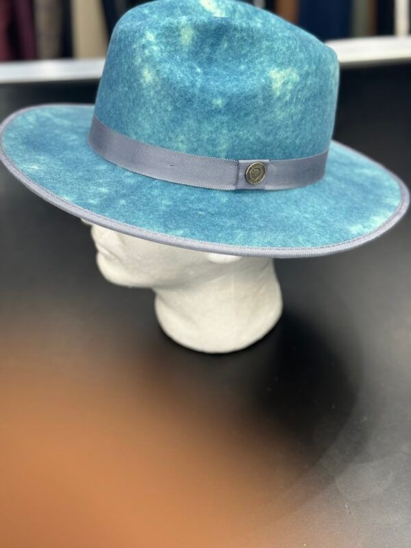 A blue hat is sitting on top of a mannequin head.