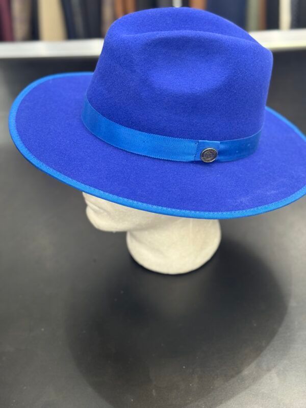 A blue fedora hat is on a mannequin head.