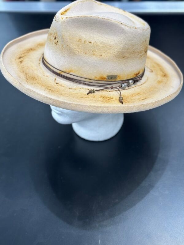 A cowboy hat is sitting on a mannequin head