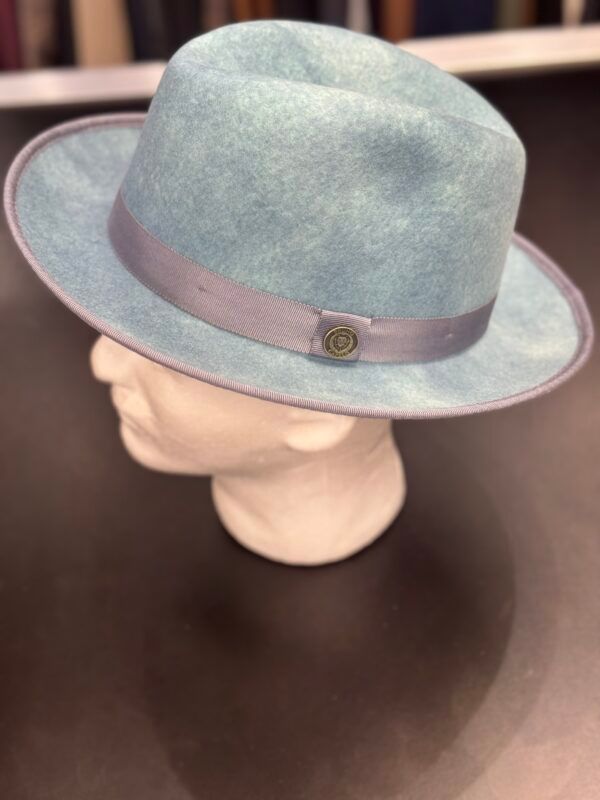 A light blue fedora hat is on a mannequin head.