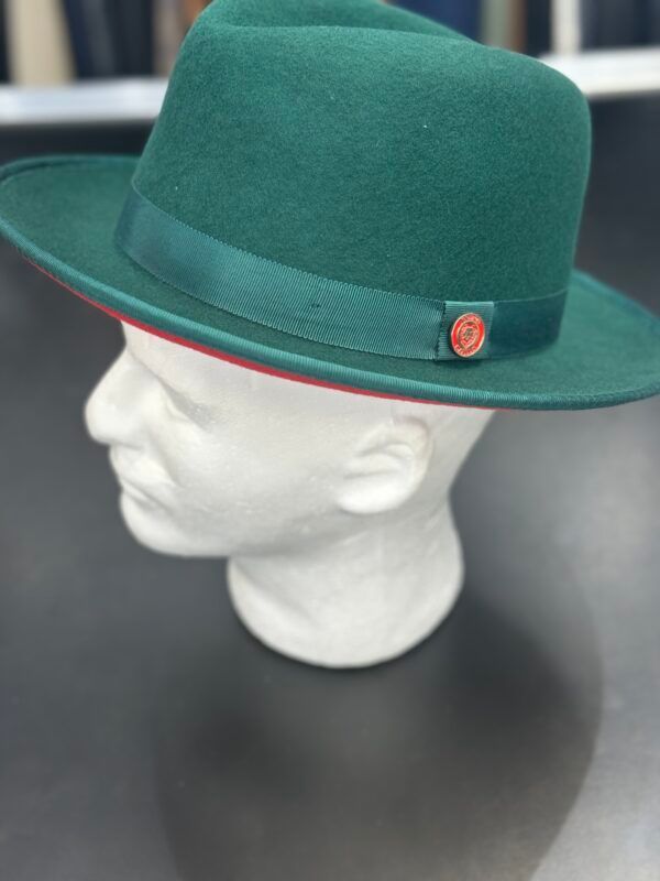 A green fedora hat is on a mannequin head.