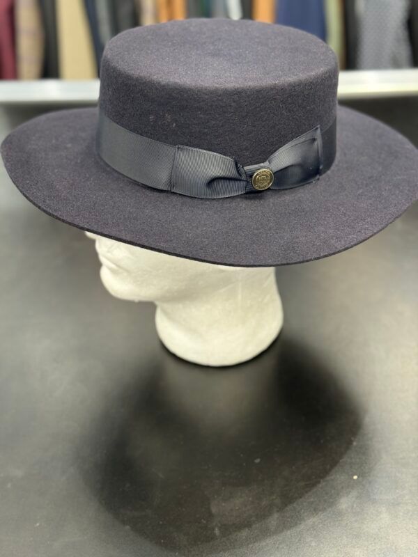 A black hat with a black ribbon is on a mannequin head.