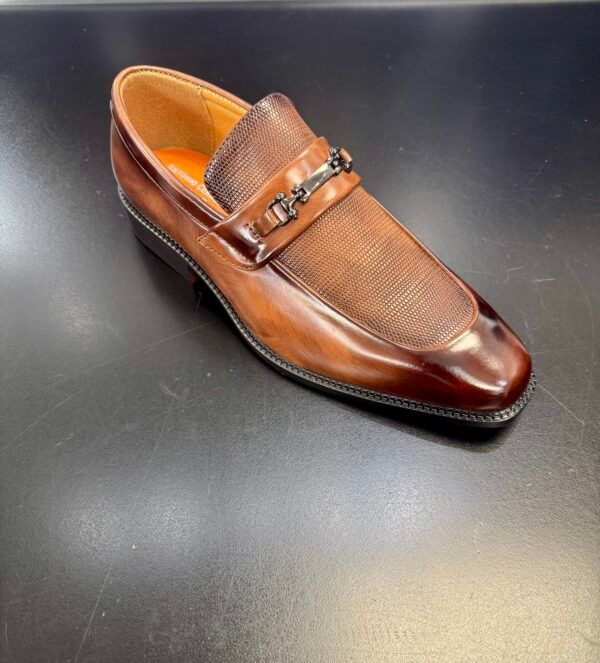A close up of a brown shoe on a table