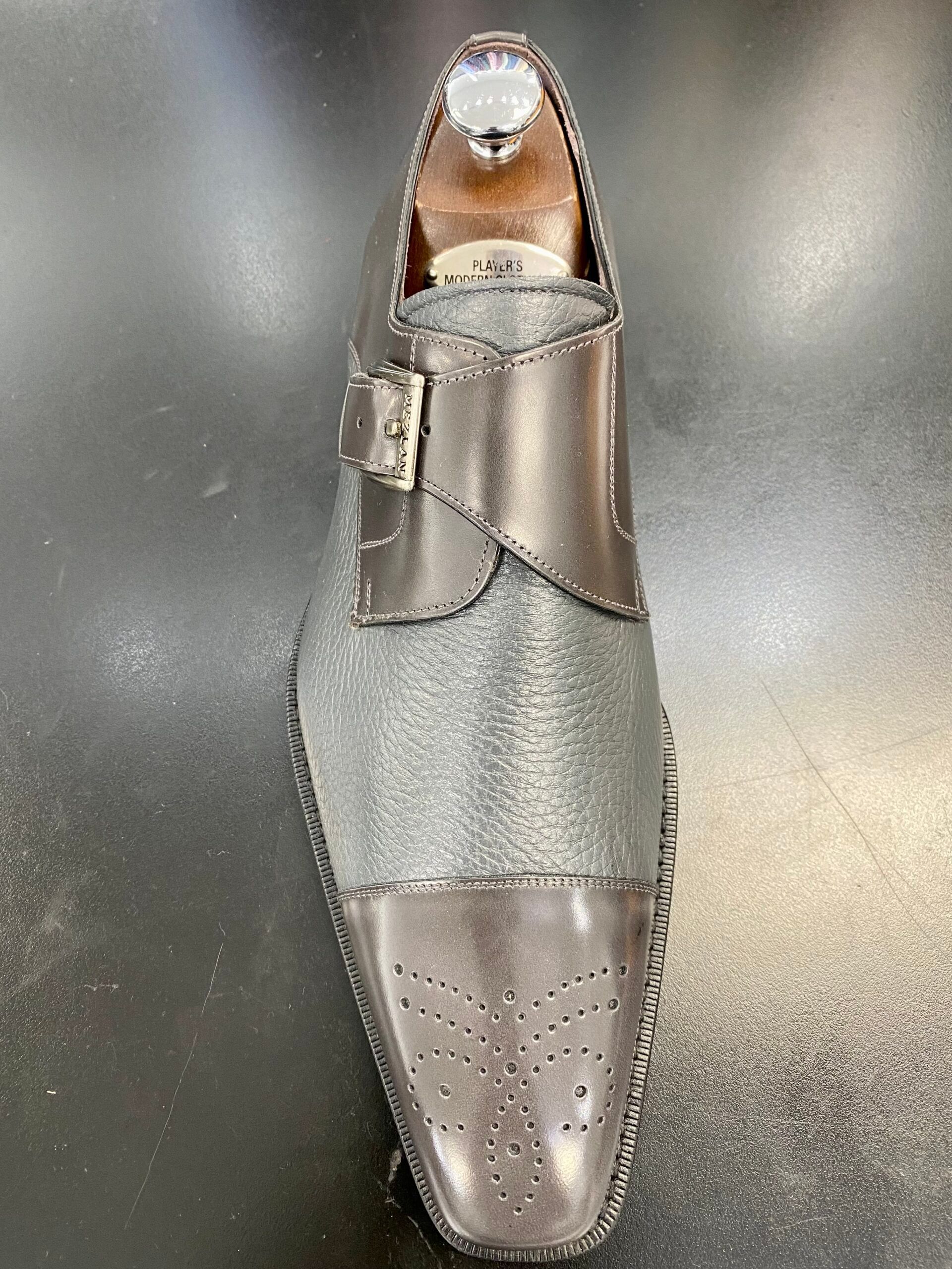 A pair of shoes sitting on a black surface