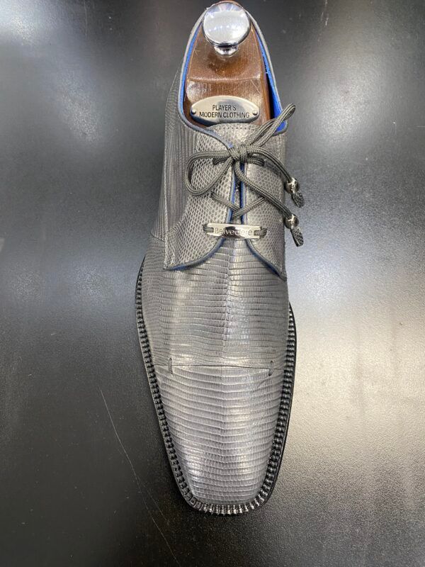 A pair of shoes is sitting on a black table.