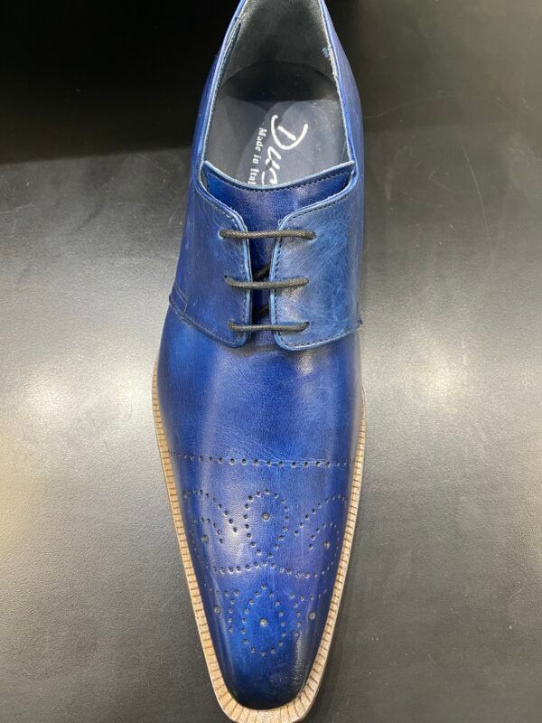A close up of a blue shoe on a black surface.