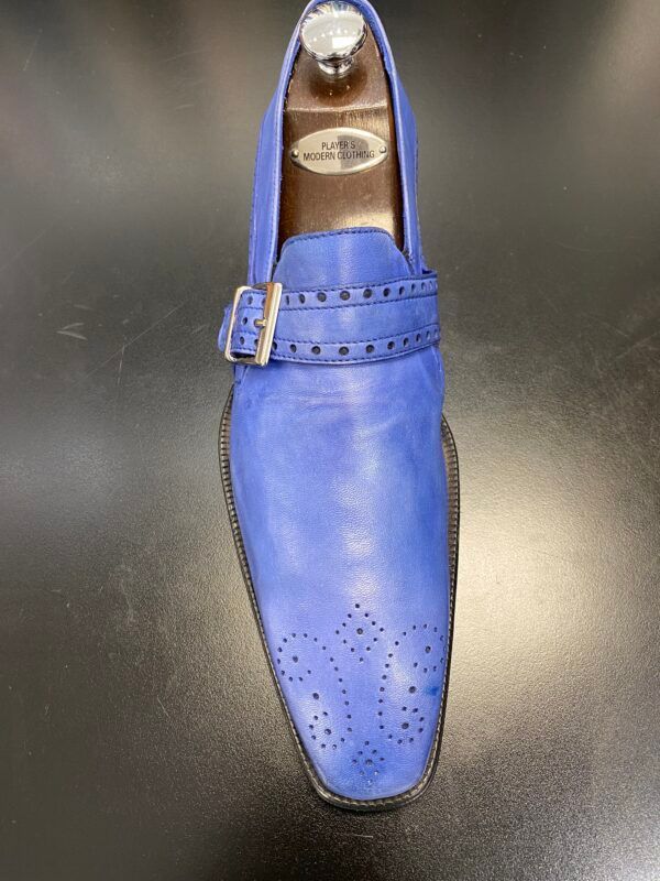 A pair of blue shoes with a buckle on the side