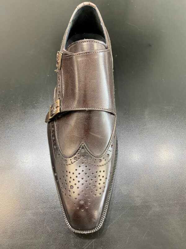 A pair of brown monk strap shoes on a black surface.