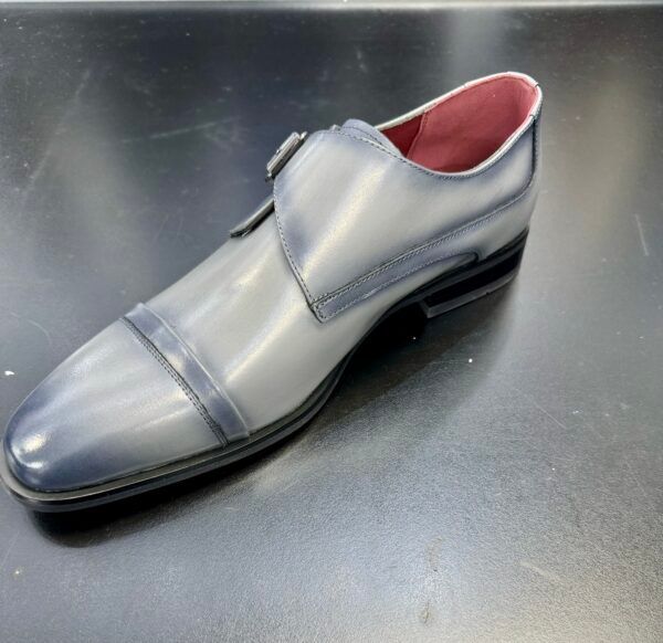 A pair of grey shoes with a red lining