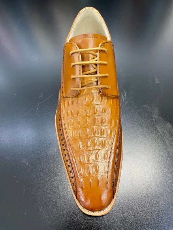 A pair of brown shoes with laces on a black surface.